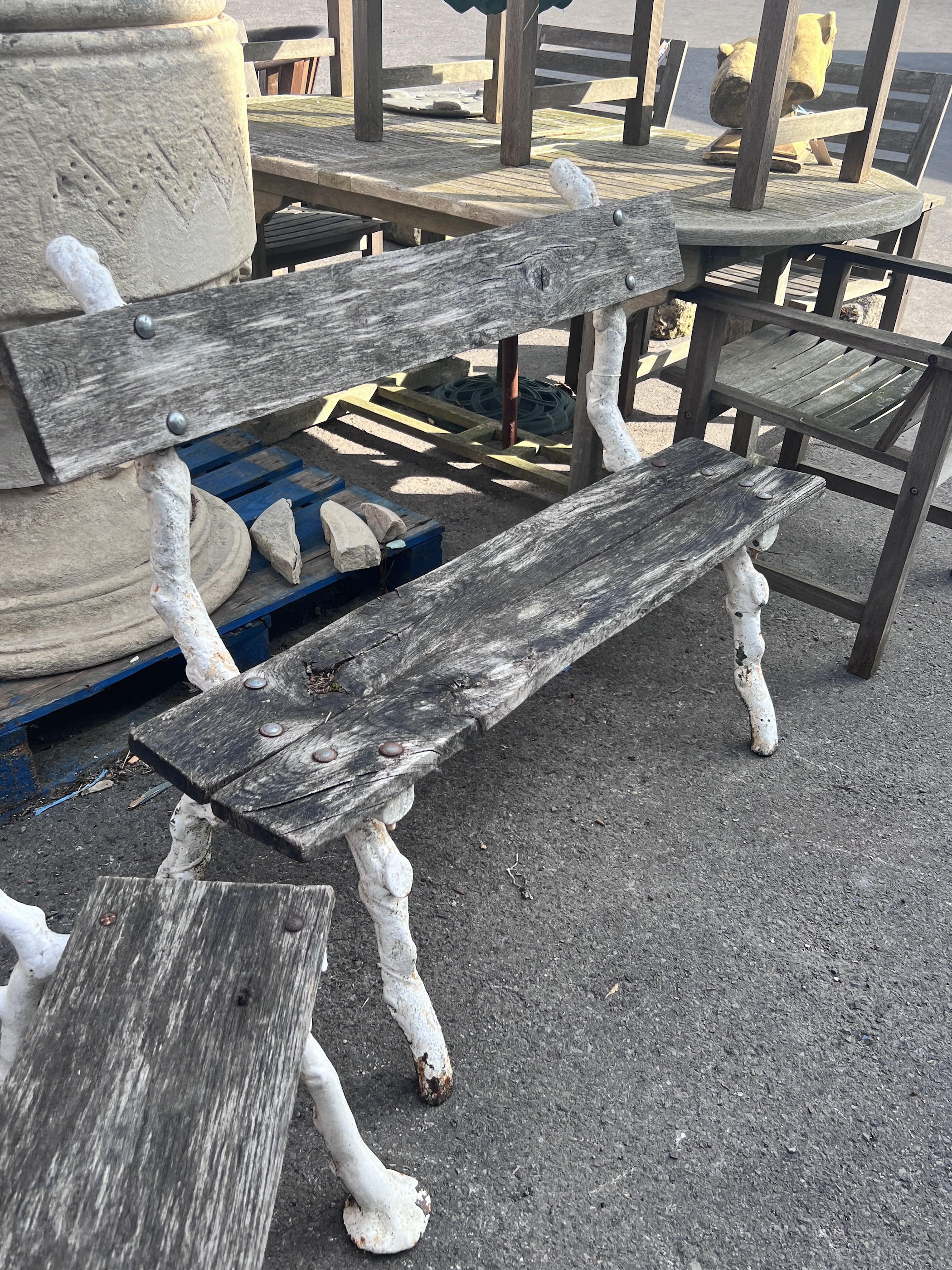 A Victorian Coalbrookdale style 'rustic' cast iron garden bench, larger width 119cm, height 87cm and a chair